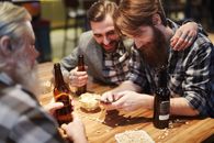 Man Using his Phone at a Bar