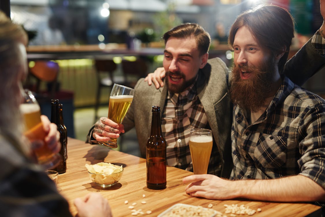 Free Men Talking at a Bar Stock Photo