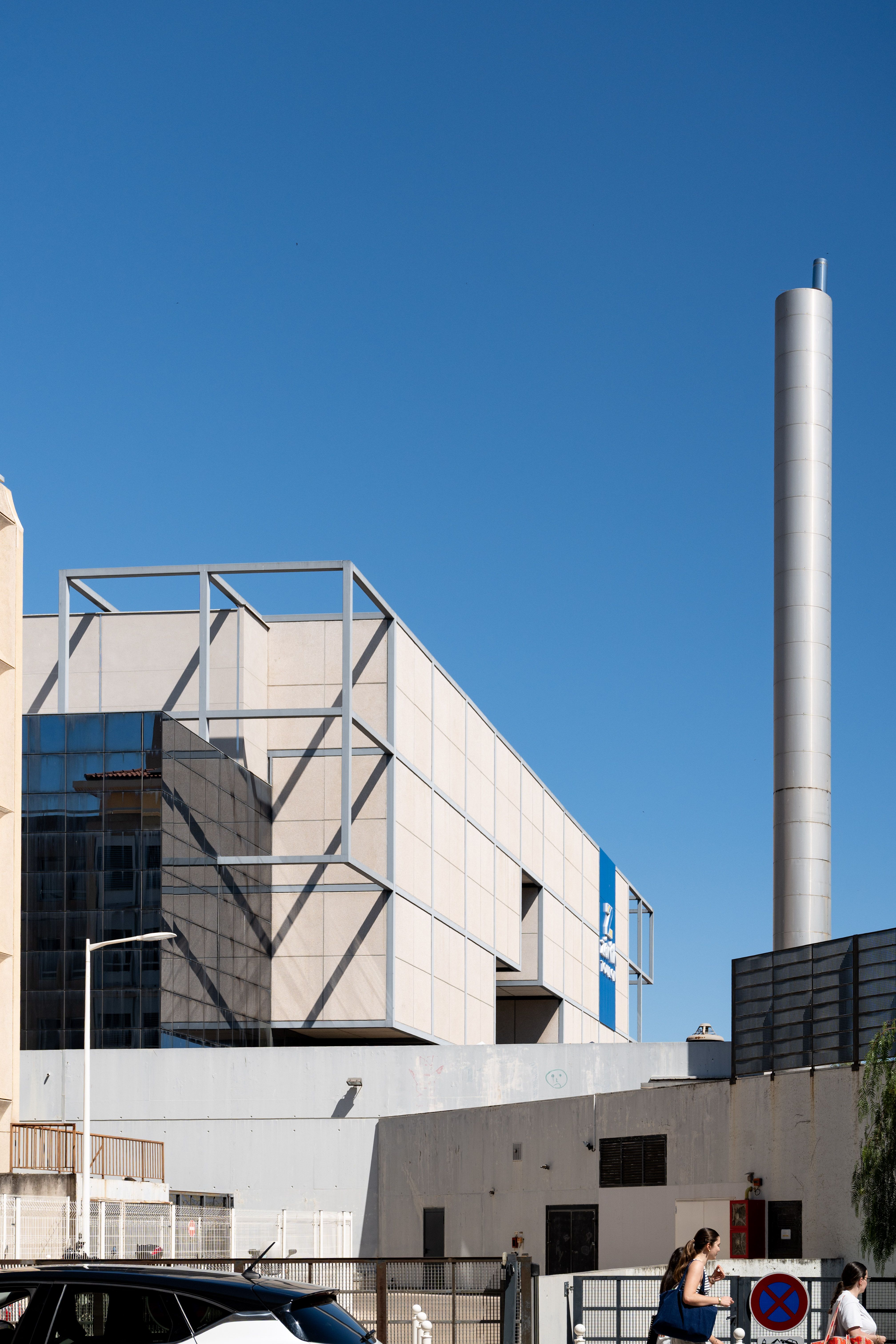 Contemporary industrial architecture with blue sky in Toulon, France, showcasing geometric design and urban lifestyle.