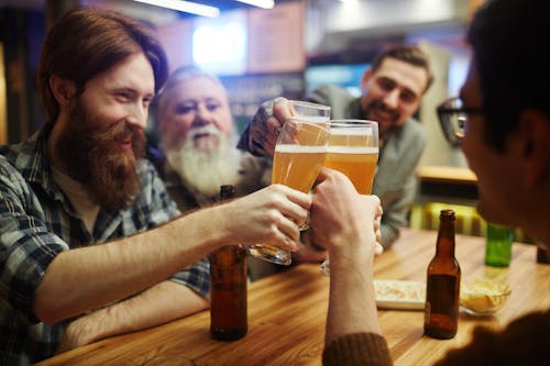 Free Men Toasting at a Bar Stock Photo