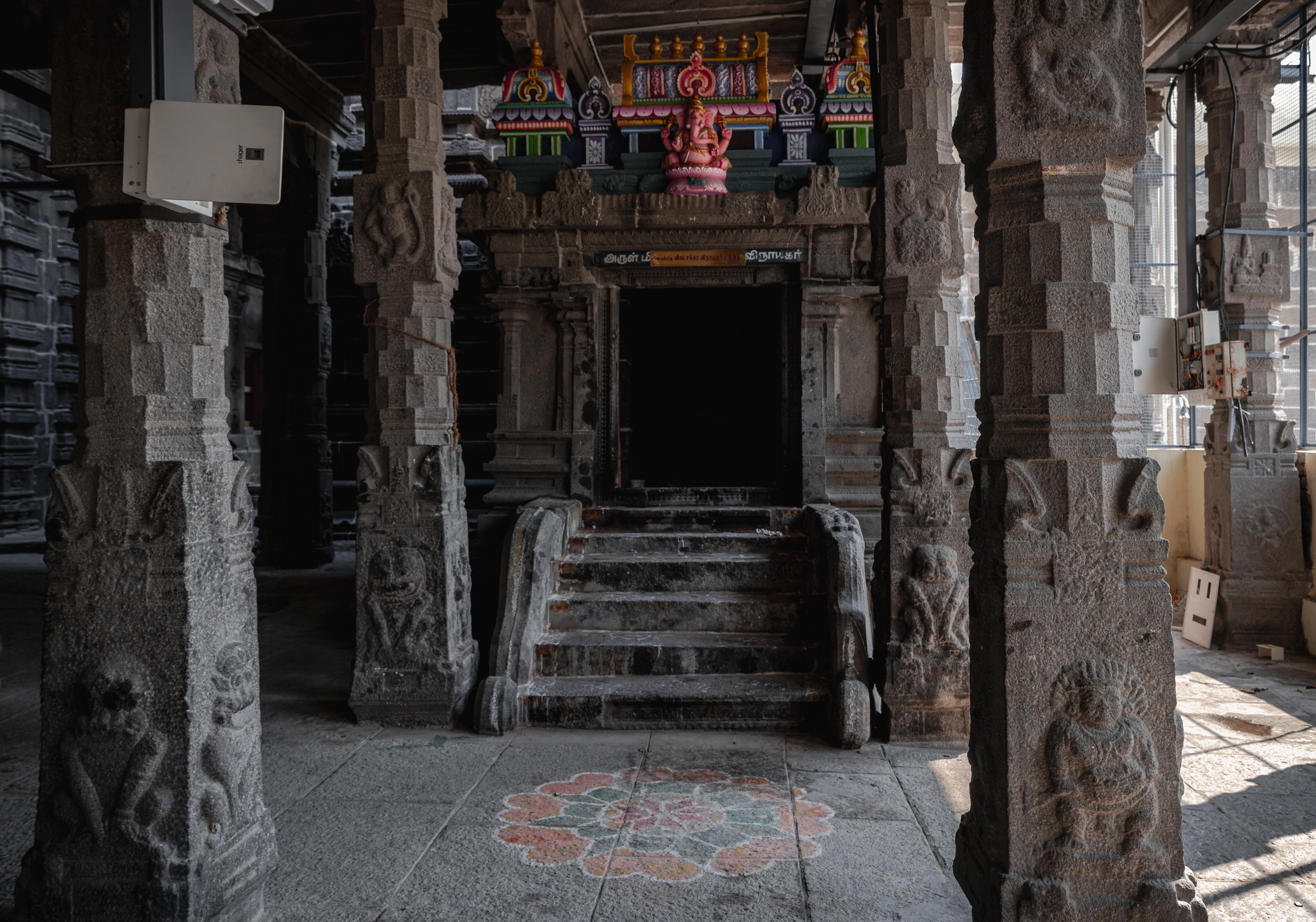 Explore the detailed stone carvings and traditional architecture of a temple in Kanchipuram, Tamil Nadu, India.