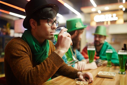 Free Man Drinking Green Beer Stock Photo
