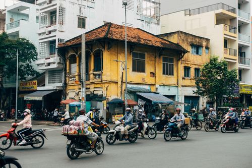 Free A lively urban scene with numerous people riding motorcycles on a city street. Stock Photo
