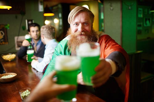 Man Holding Green Beer Glass