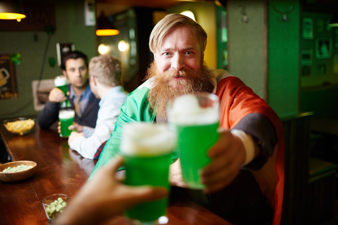 Free Man Holding Green Beer Glass Stock Photo
