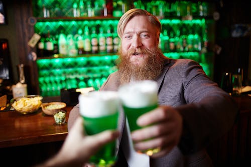 Man Toasting With Green Beer