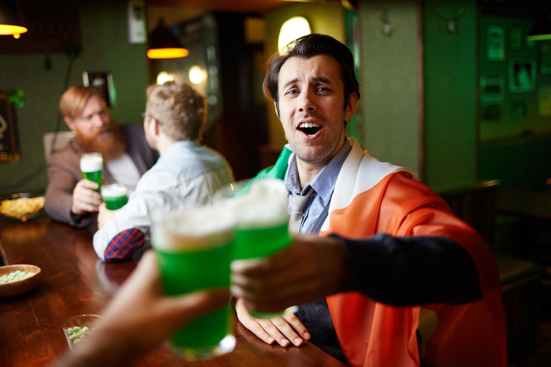 Free Men Toasting at a Bar Stock Photo