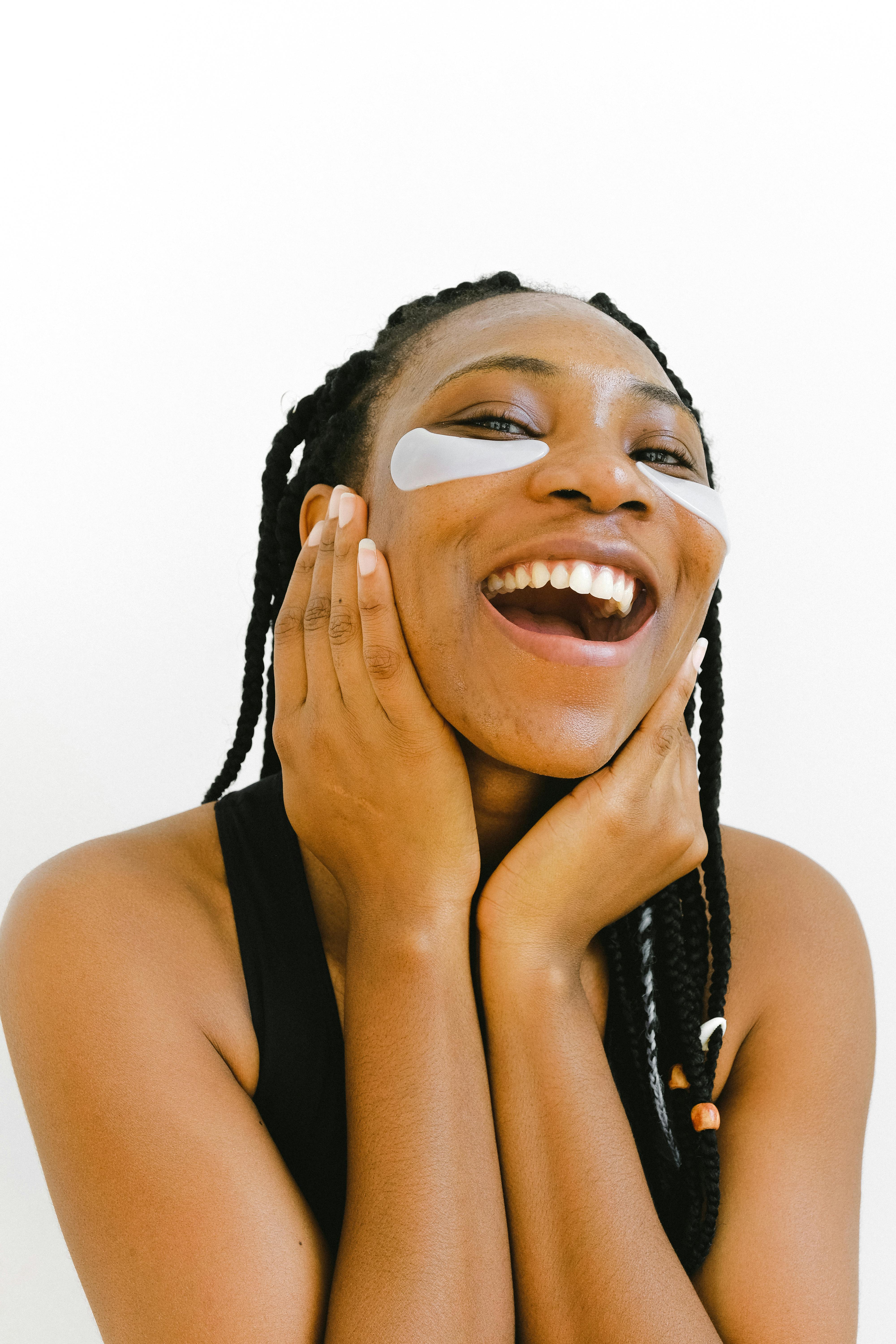 black happy woman with afro braids laughing