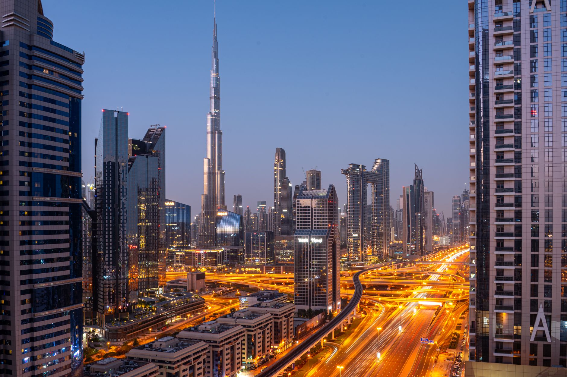 A modern luxury law firm boardroom with a view of a city skyline at night, symbolizing 24/7 legal vigilance.