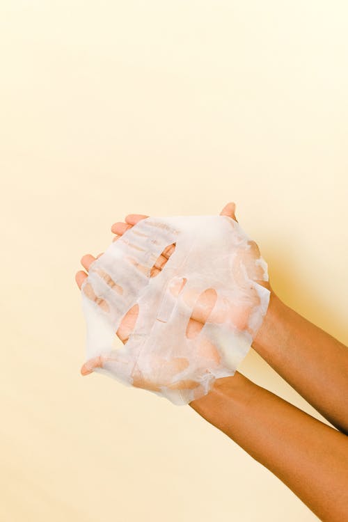 Free Person Holding A Face Mask Stock Photo