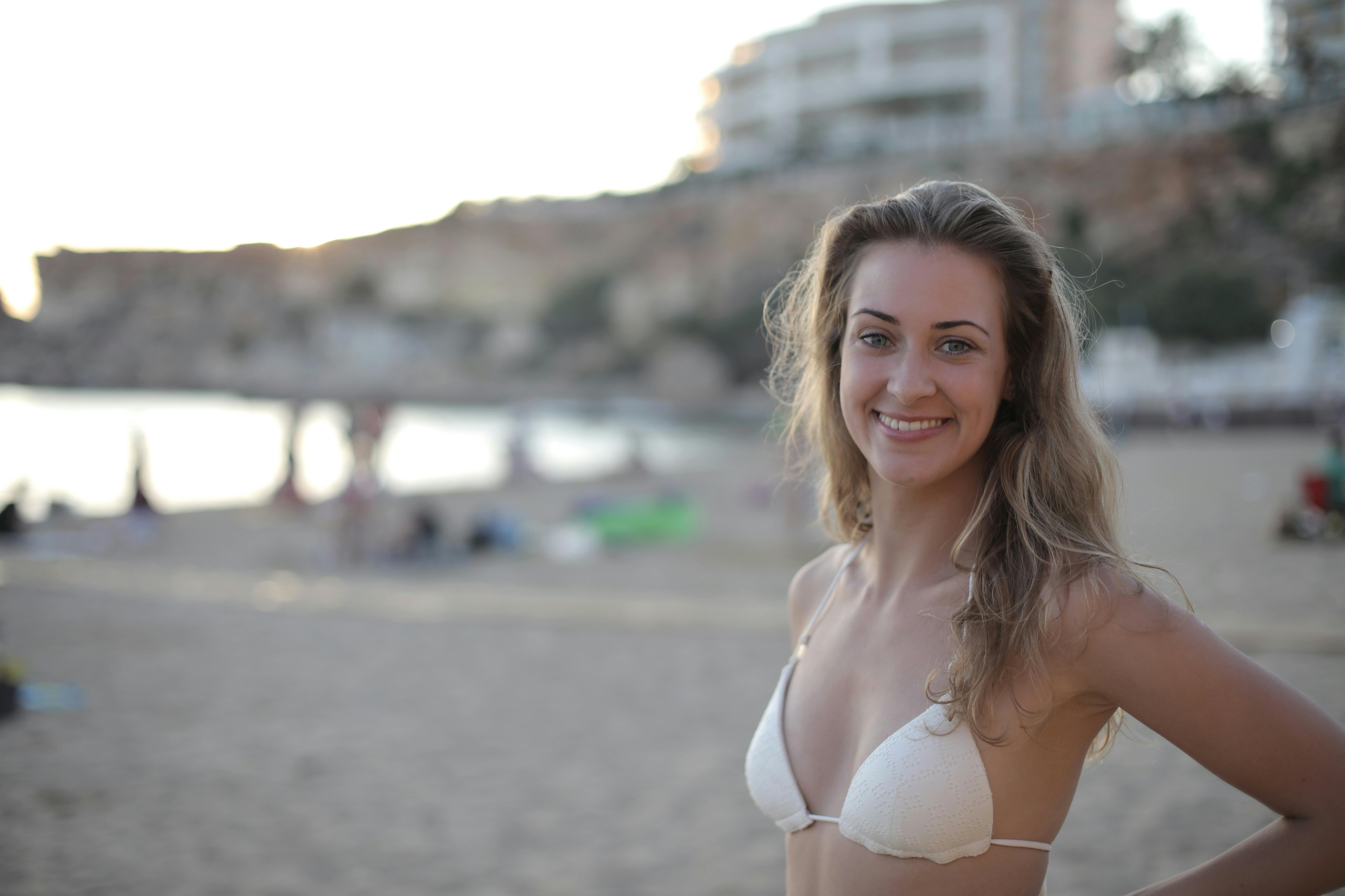 Woman with small breasts in White Bra Smiling