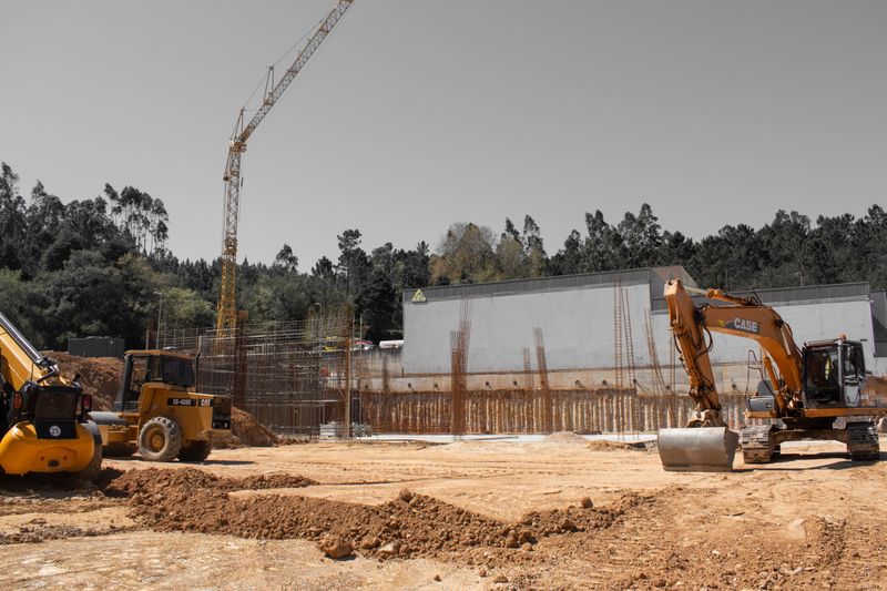 A busy construction site with cranes and heavy machinery for building infrastructure