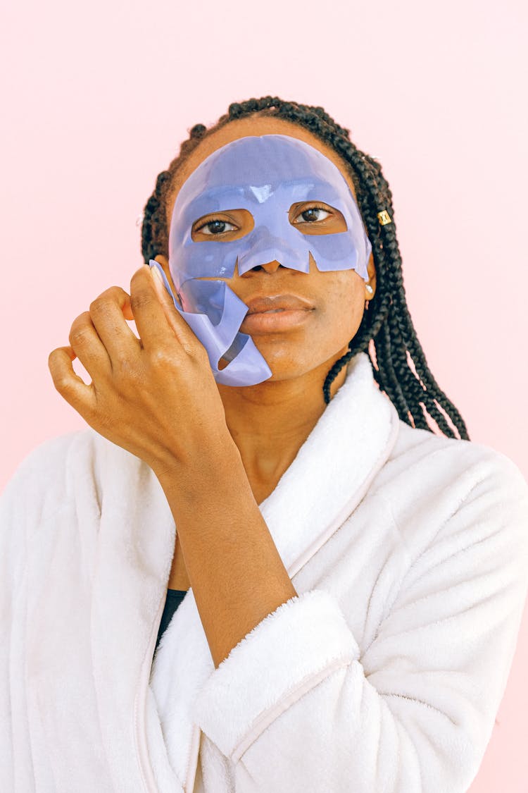 Woman In White Robe With White Face Mask