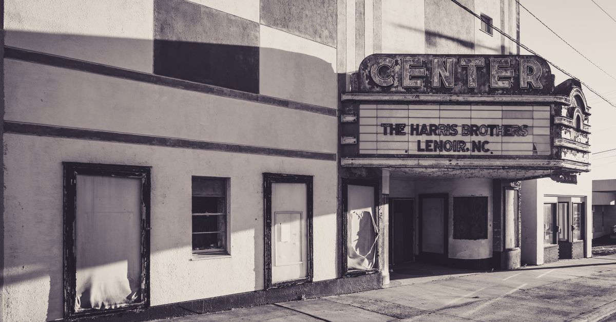 Black and white photo of an old cinema with marquee in Lenoir, NC.