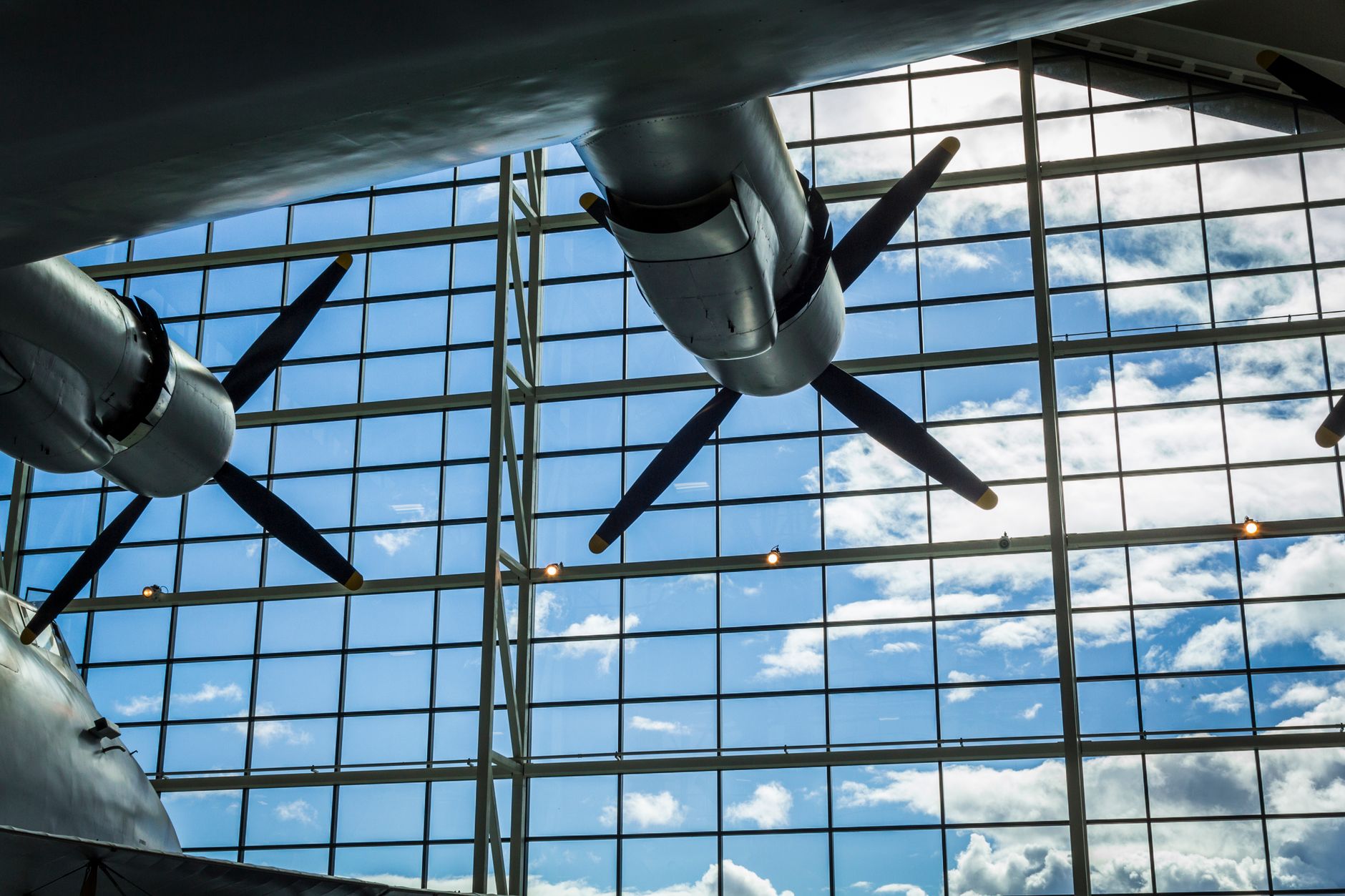 Close-up of airplane propellers against a bright sky at McMinnville museum.