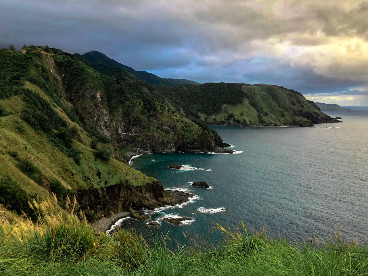 explore the stunning coastal cliffs of the philippines with lush green