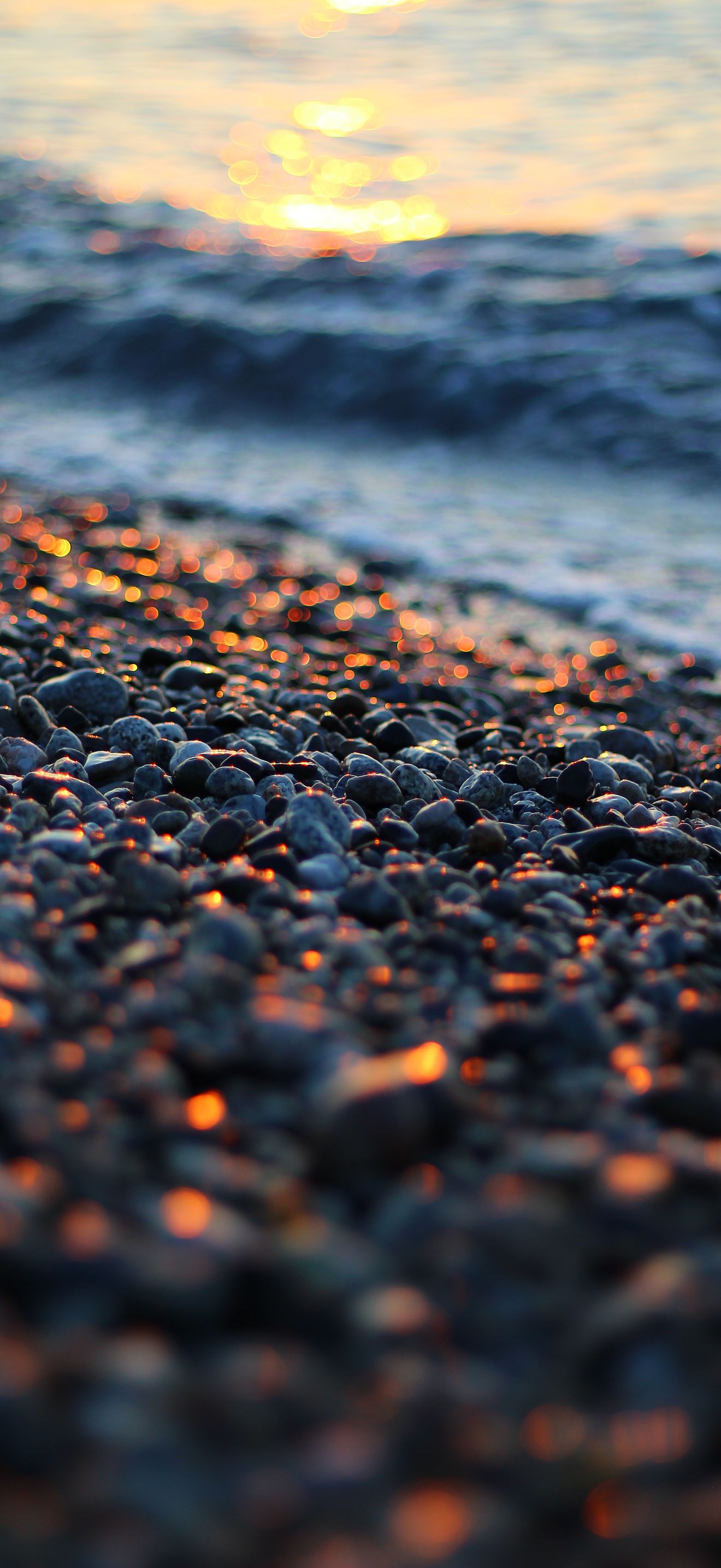 Sunset Light on Pebbles Calabria Beach 4K iPhone 17 Wallpaper