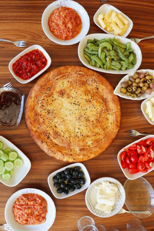 Free A top-view of a traditional Middle Eastern brunch with savory pastries and fresh vegetables. Stock Photo