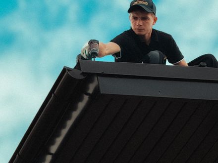 Newly installed seamless gutter and downspout on a home