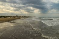 A moody beach scene with dramatic clouds at Lido di Jesolo, Italy.