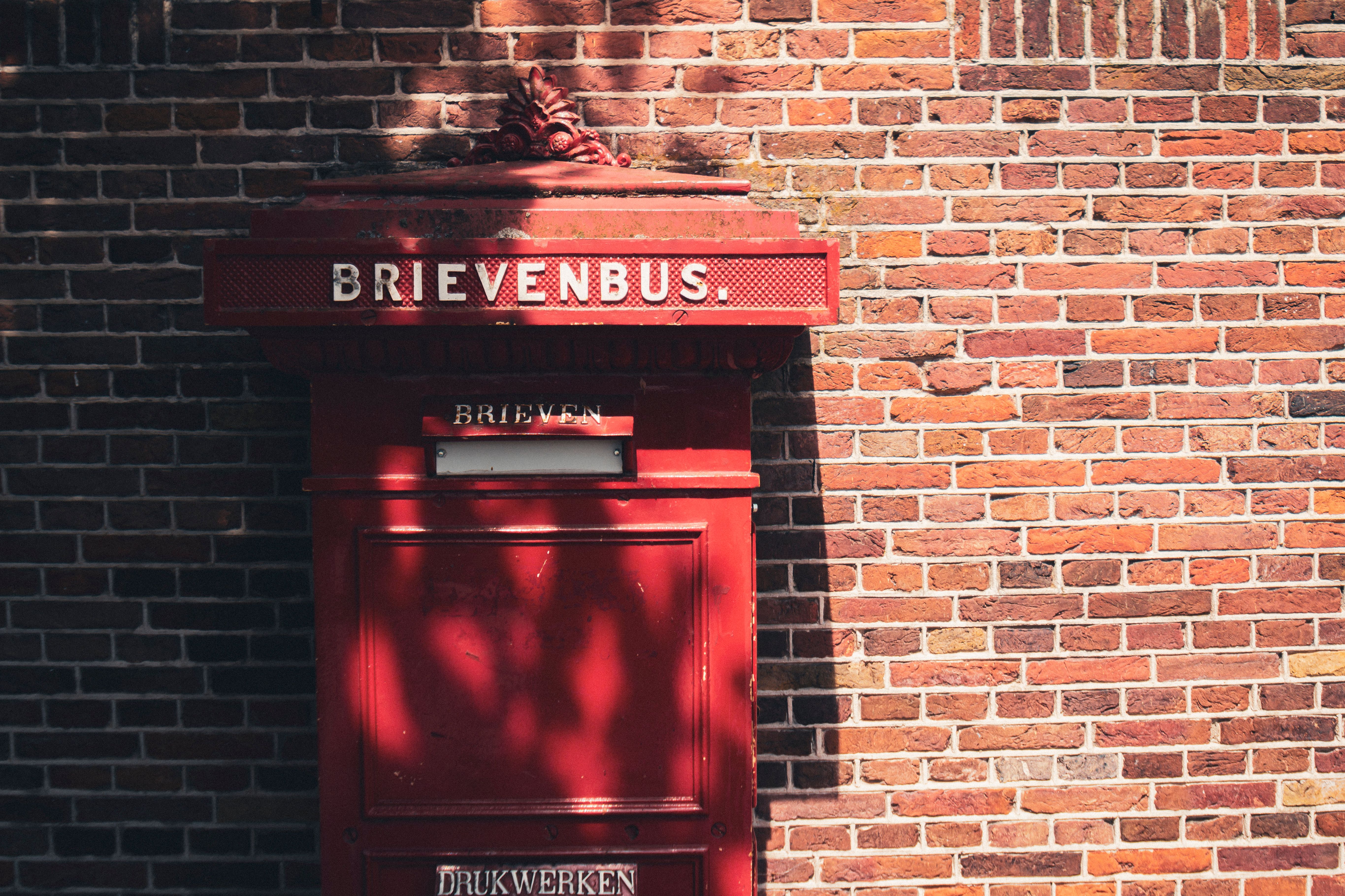 Classic Dutch mailbox in Zaandam set against a textured brick wall, showcasing traditional design.