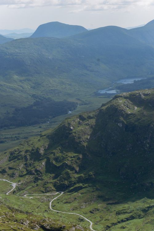 Free A breathtaking view of Killarney's lush mountains and winding roads on a sunny day. Stock Photo