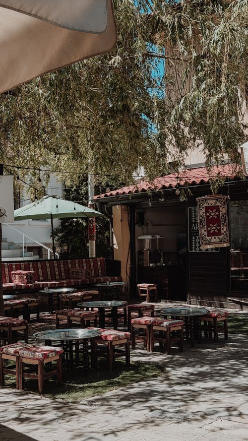 Free Explore the tranquility of a traditional outdoor cafe setting in Bosnia with rustic decor and shaded seating. Stock Photo