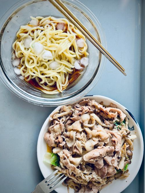 Free A close-up of ramen served with stir-fried pork and vegetables, capturing a tasty Asian meal. Stock Photo