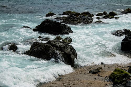 Free Waves crash against rocky shorelines in Zihuatanejo, showcasing nature's raw beauty and power. Stock Photo