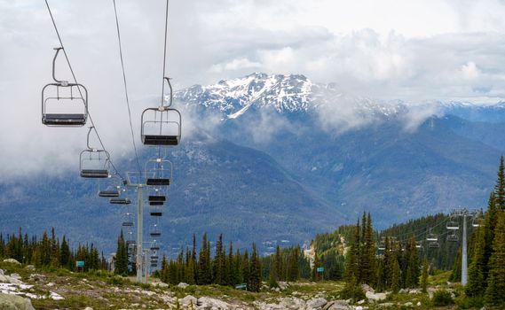 Empty ski lift with mountainous backdrop in summer, Whistler
