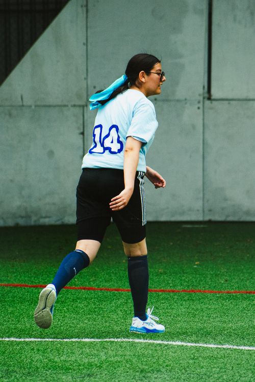 Free Young woman playing soccer on an outdoor field in Mexico City. Stock Photo