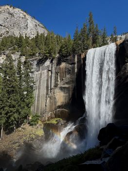 Breathtaking waterfall and rainbow in Yosemite, California.