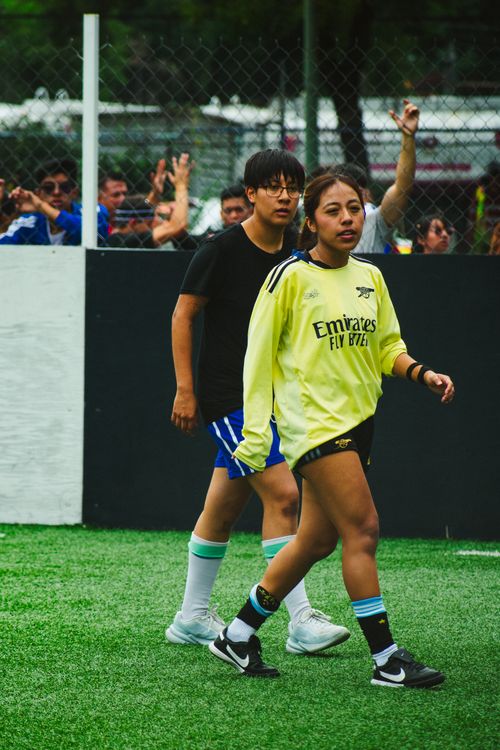 Free Two women playing soccer on a vibrant sports court in Mexico City, showing determination. Stock Photo