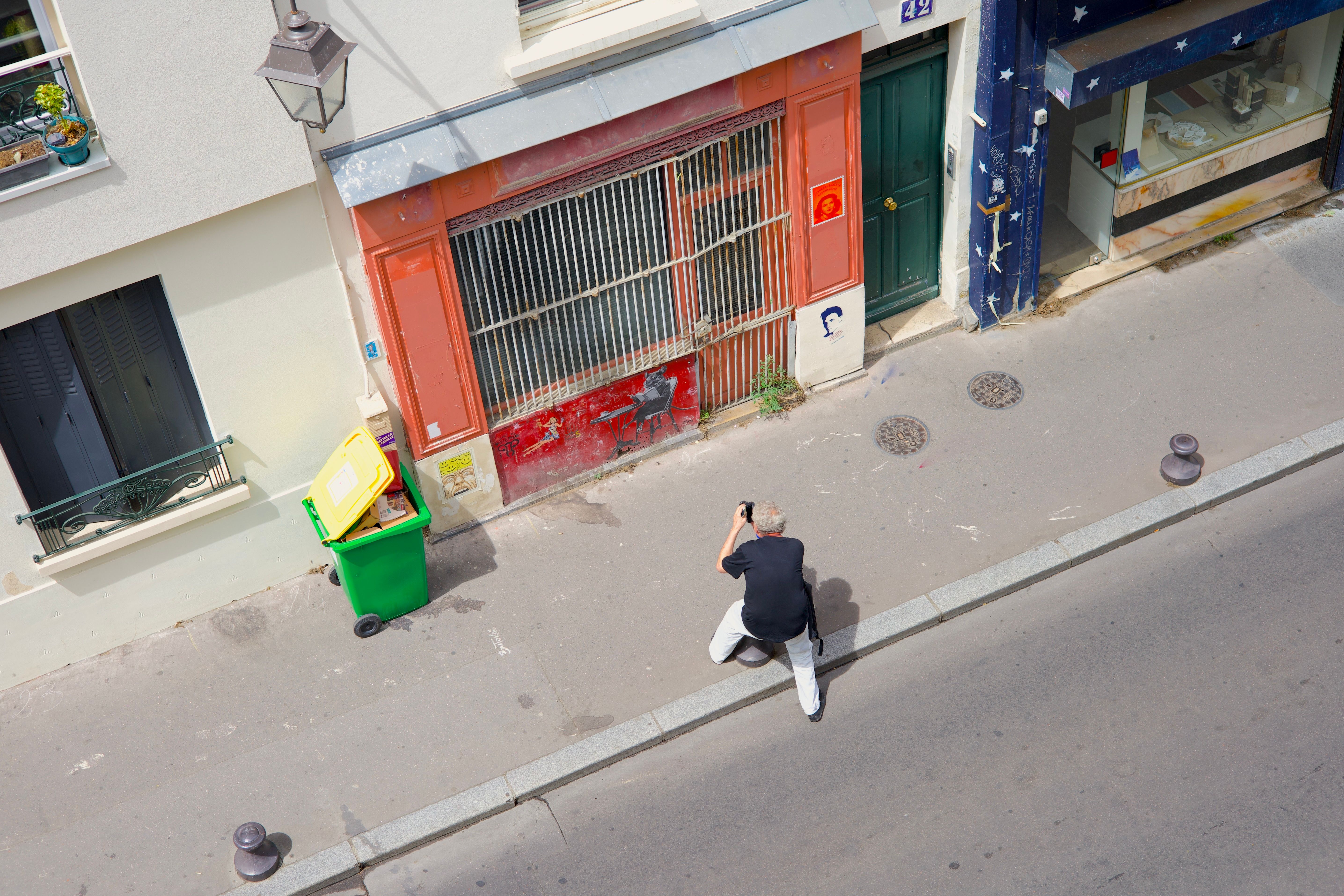 A street photographer captures a scene in Paris, showcasing urban vibes from above.