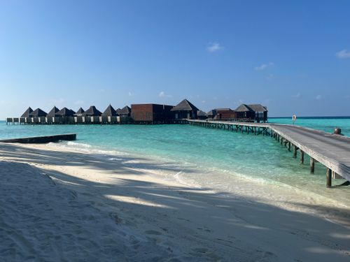 Free Stunning overwater villas in Maldives with a serene view of turquoise sea and sandy beach. Stock Photo