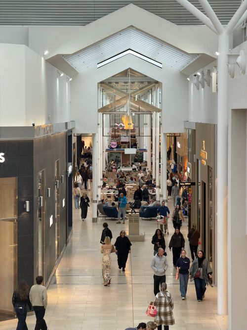 Free Vibrant shopping mall corridor bustling with diverse shoppers and modern architecture. Stock Photo