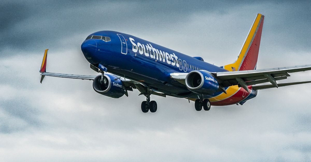 Photo by Marvin Filmaker A Southwest Airlines plane flying in a dramatic cloudy sky, showcasing dynamic weather conditions.