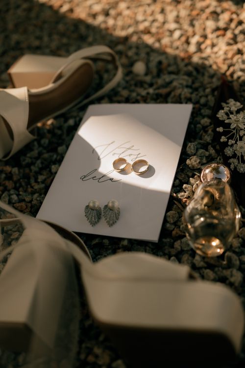 Free Elegant wedding flat lay with rings, shoes, and perfume on gravel background for a charming outdoor celebration. Stock Photo