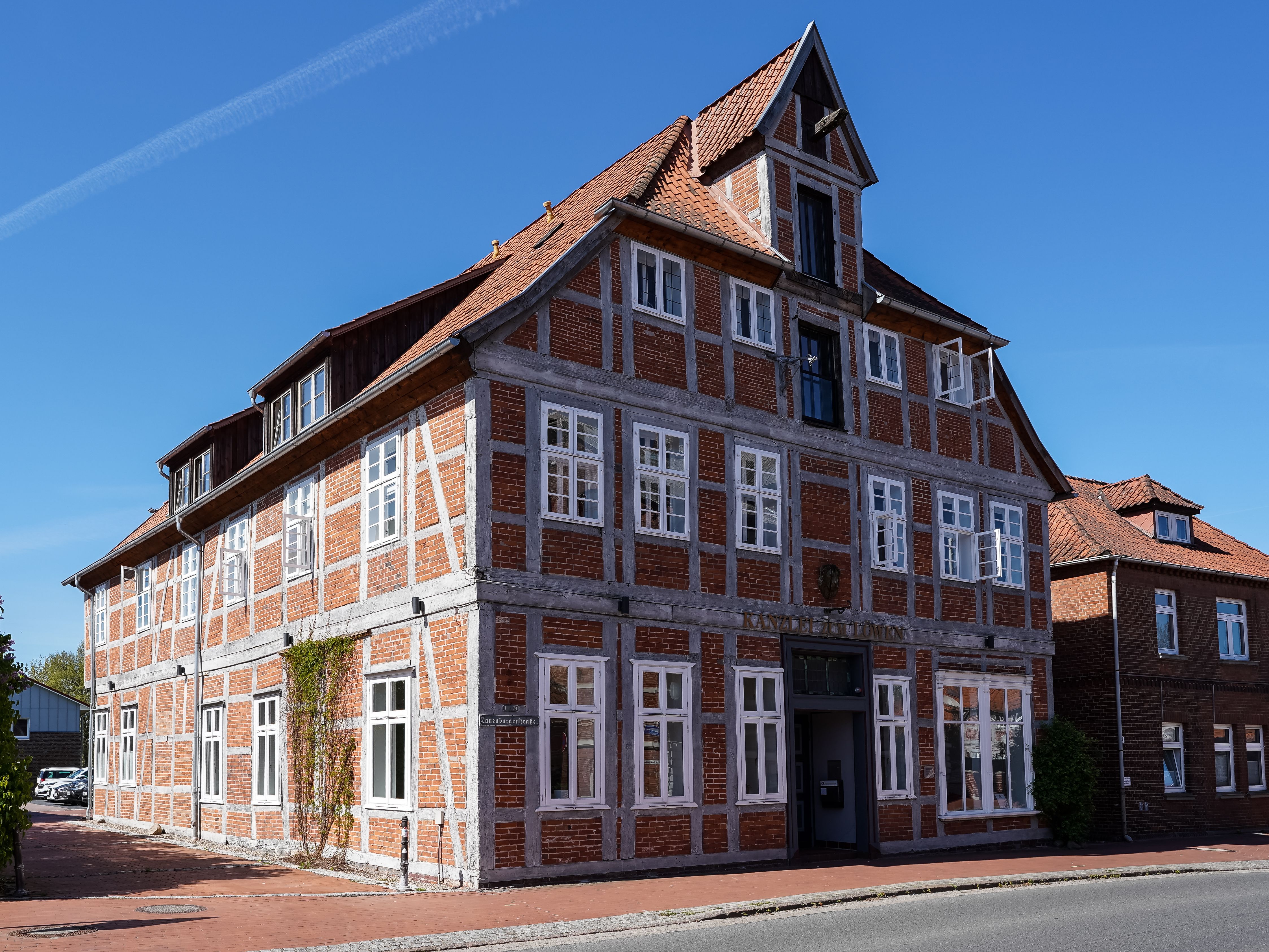 Charming historic timbered house in Bleckede, Germany under a clear blue sky.