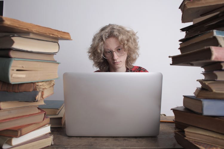 Focused Teen Boy Studying On Laptop