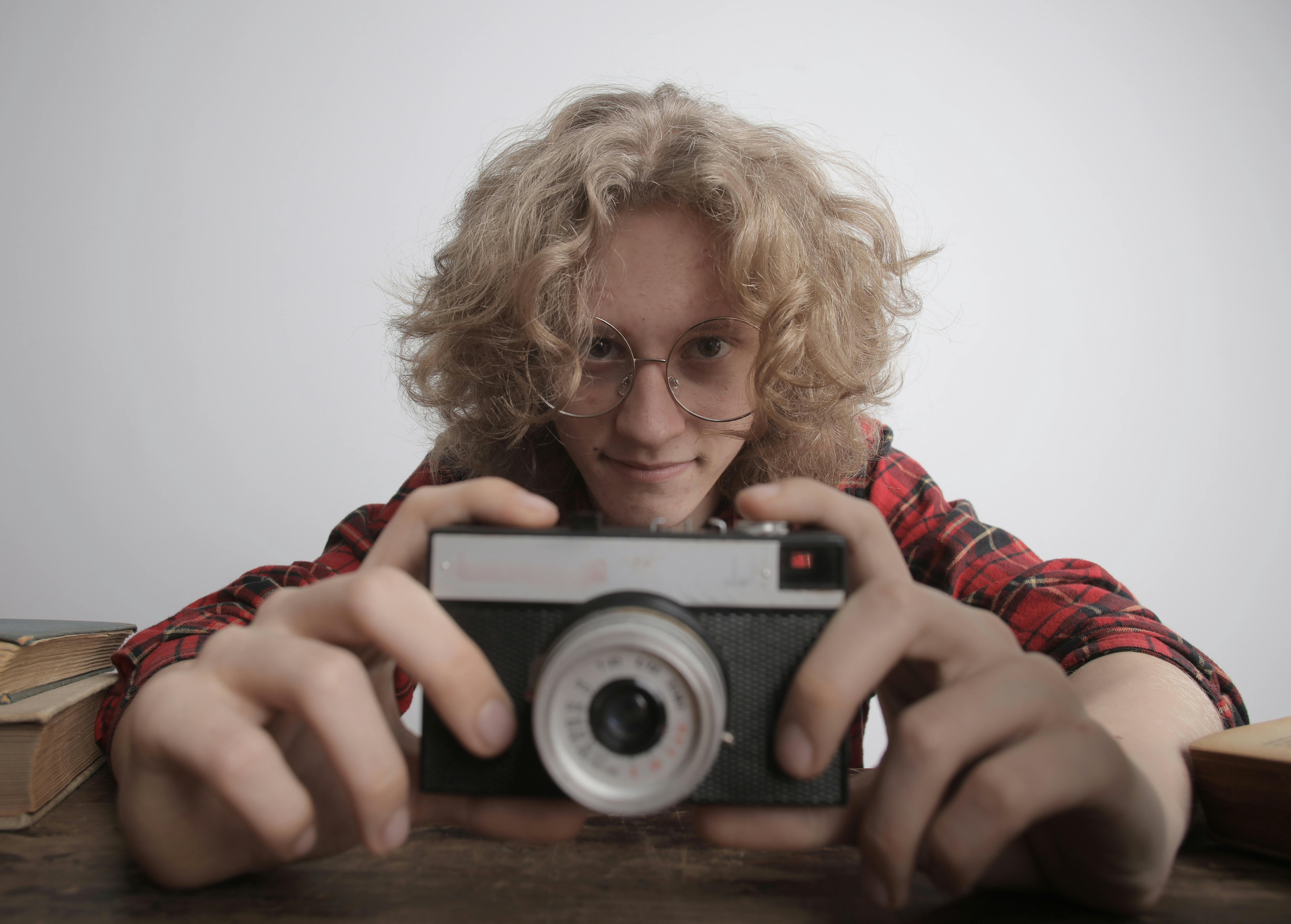 positive teenager with vintage camera