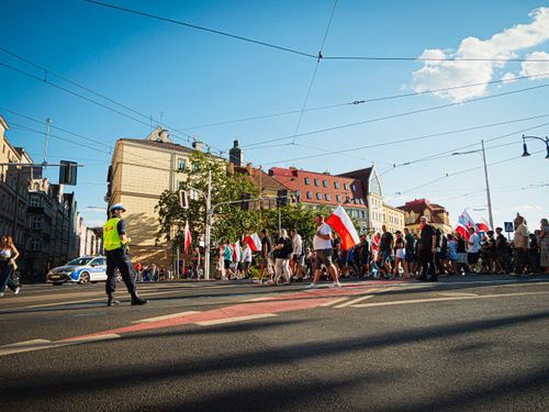 Free A crowd participates in a peaceful march in Wrocław, Poland, under a sunny sky. Stock Photo