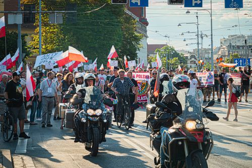Free People marching in Wrocław, Poland, commemorating historical events with flags and signs. Stock Photo