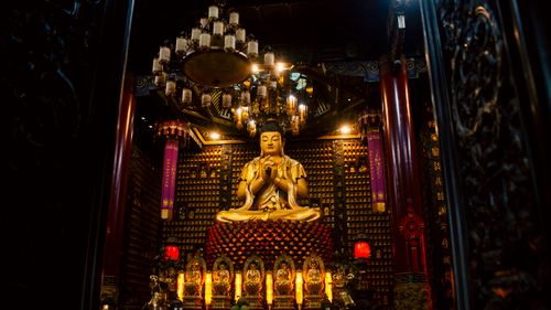 Free Intricately decorated Buddhist shrine featuring a golden statue in Ho Chi Minh City, Vietnam. Stock Photo