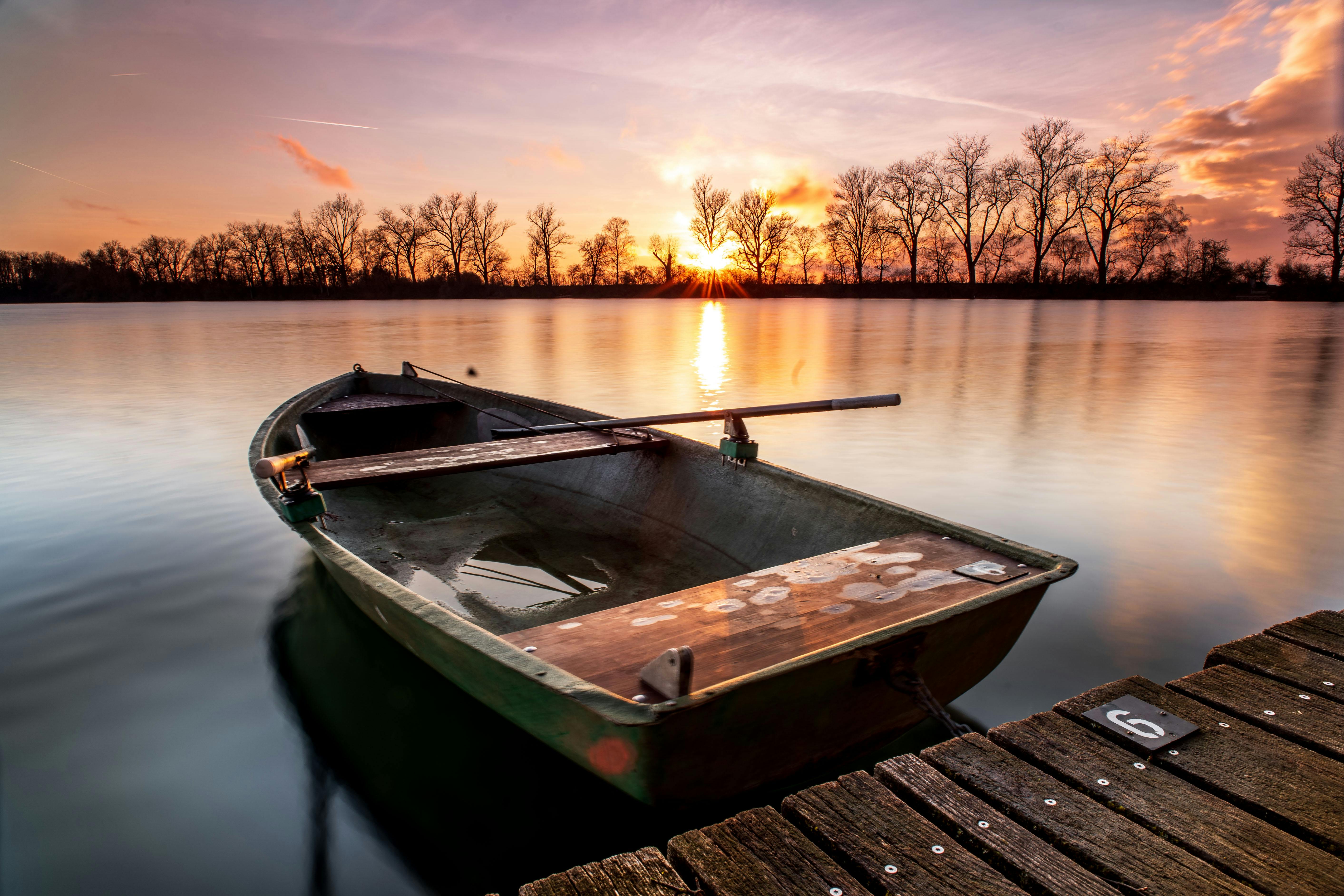 Brown Wooden Boat On Dock During Sunset Free Stock Photo