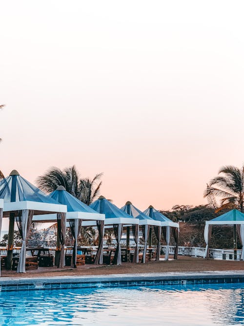 Free Poolside with coy umbrellas during sunset Stock Photo