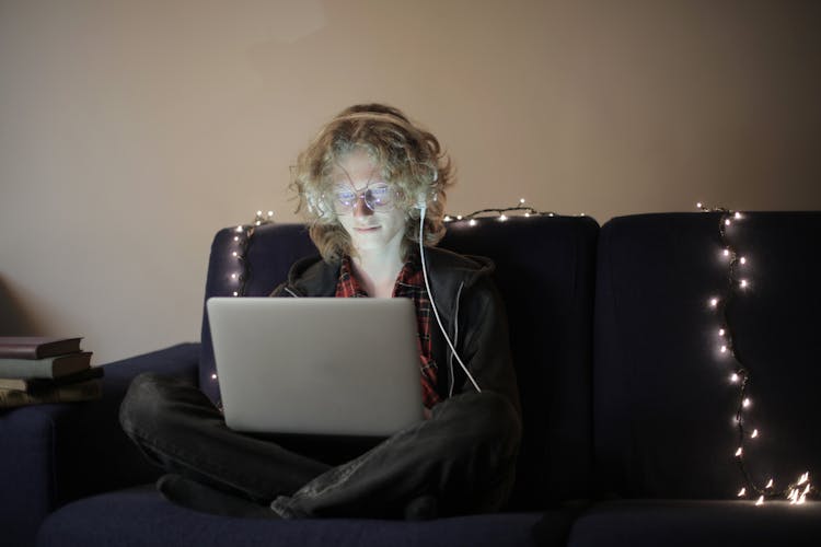 Positive Teenager Using Laptop In Living Room