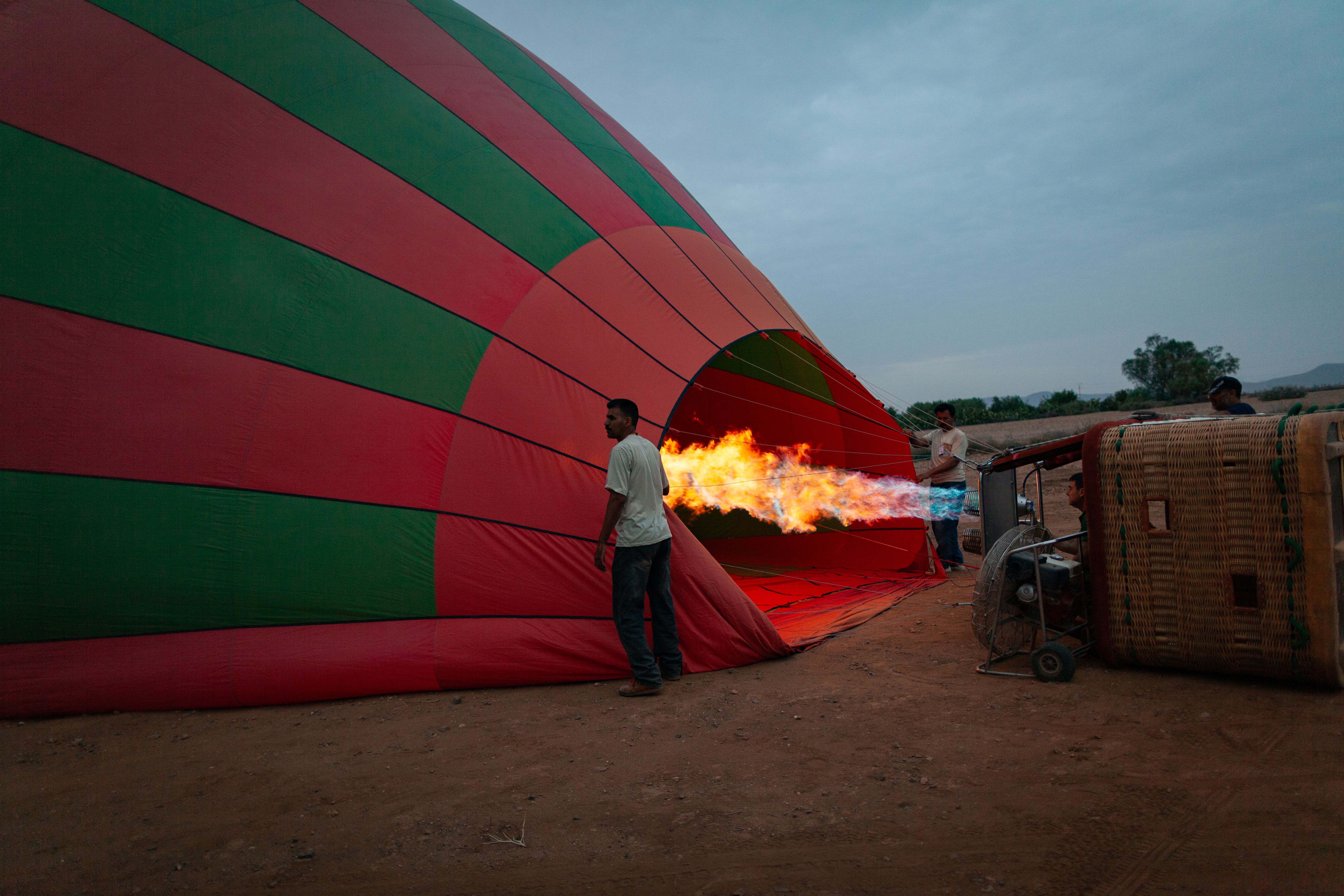 Hot air balloon being inflated at sunrise near Marrakech, Morocco
