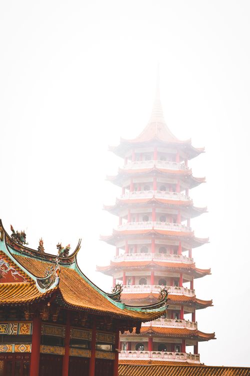 Free Elegant Chinese pagoda surrounded by mist, showcasing intricate architectural details. Stock Photo