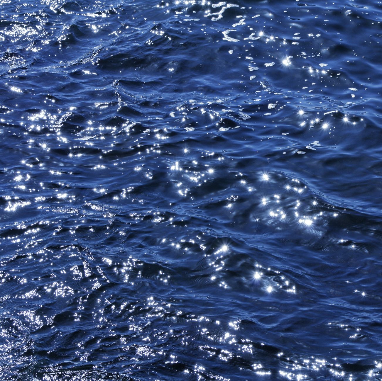 Glittering sunlight on ocean waves captured at Sidi Ifni, Morocco.